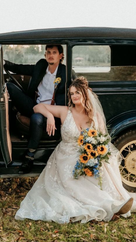 Sunflowers and blue delphinium in a gorgeous cascading wedding bouquet