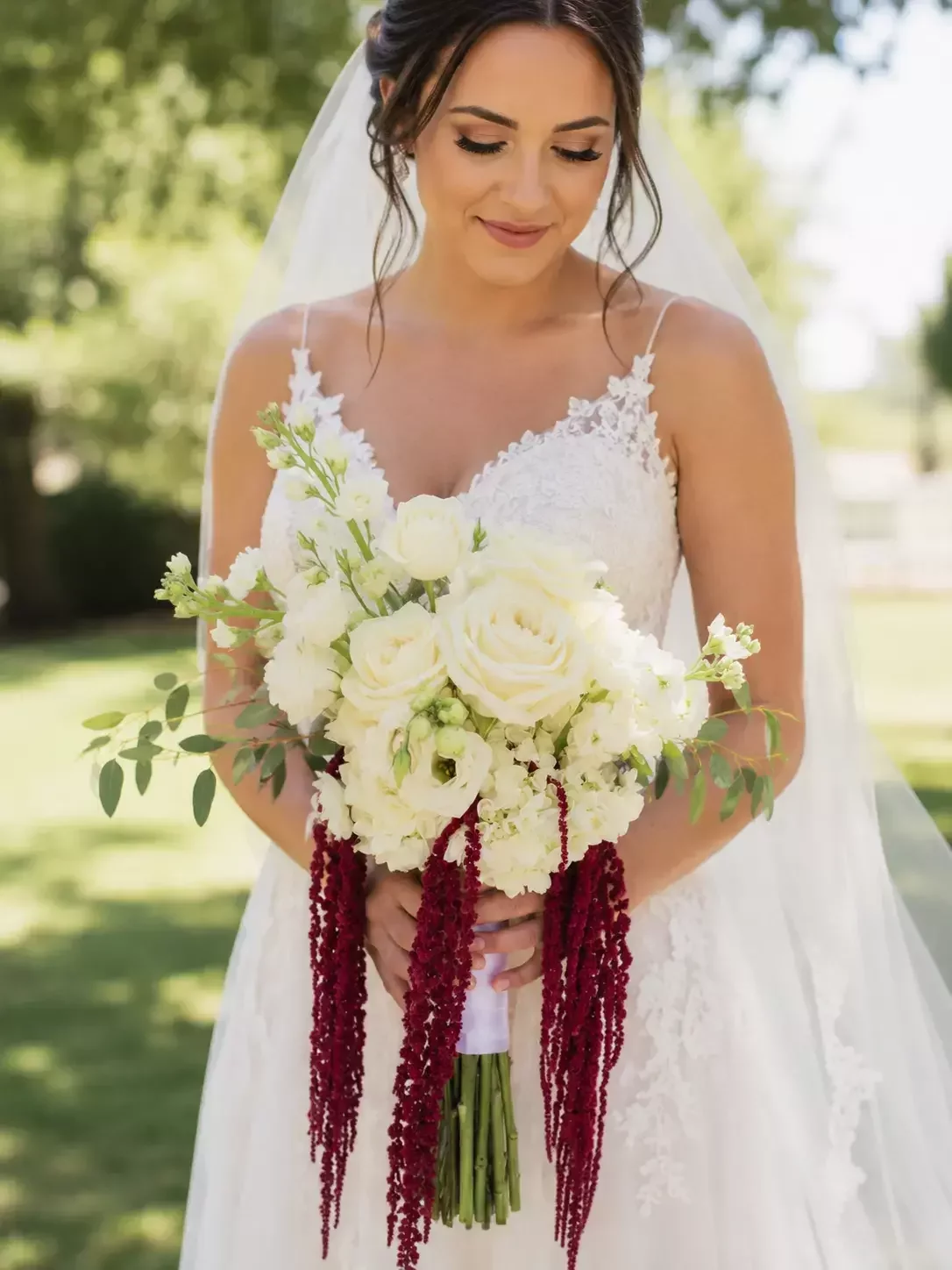 White rose and hydrangea bridal bouquet with dramatic hanging burgundy amaranthus