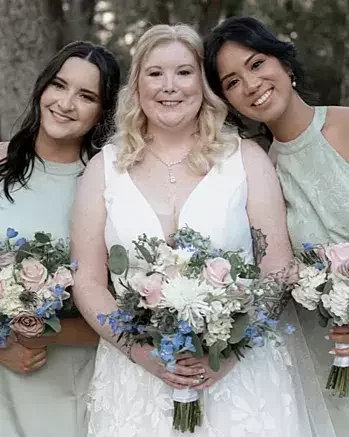 Bridal party bouquets of white and blush flowers with blue delphinium and greenery for a Tampa wedding