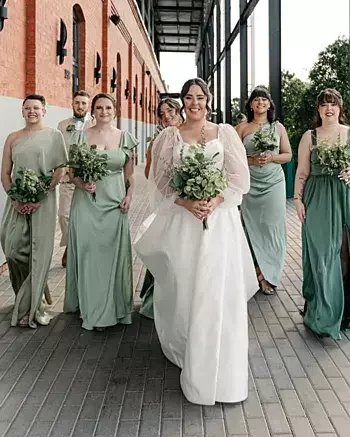 Bride and bridesmaid carrying all-eucalyptus greenery bouquets at a Tampa Bay wedding